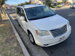 2010 Chrysler Town & Country Touring van parked on the street, perfect condition, only 139,000 miles, great for family or work.