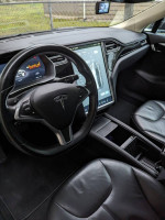 Interior of a 2014 Tesla Model S 85 with leather seats and touchscreen display