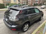 2008 Lexus RX400h hybrid SUV in Smoky Granite Mica color parked on a city street with service records.