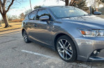 Gray 2015 Lexus CT 200h with alloy wheels parked under trees, showcasing luxury and economy in excellent condition.
