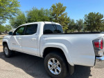 White 2022 Toyota Tacoma SR 4WD parked, showcasing alloy wheels and new tires in excellent condition.