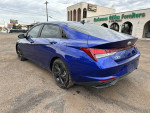 2021 Hyundai Elantra SEL in blue color parked, featuring alloy wheels and showcasing its modern design.