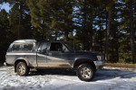 1993 Toyota Pickup 4WD with 6.5 foot bed parked in snowy forest, showcasing reliable condition and potential.