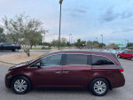 2016 Honda Odyssey SE mini-van in burgundy color parked, featuring sliding doors and spacious interior for 8 passengers.