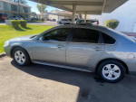 2009 Chevrolet Impala LT in silver, parked with clean body and good tires, showcasing its sleek design and features.