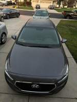 2018 Hyundai Elantra GT hatchback parked, showcasing its modern design and 17-inch alloy wheels.