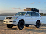 2008 Lexus GX 470 4WD in pearl white, ready for off-road adventures with camping gear on roof.