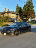 2010 Mazdaspeed3 hatchback with aftermarket mods parked in a residential area