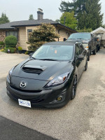 2010 Mazdaspeed3 with custom mods, brand new front tires, and enhanced stereo system parked driveway
