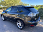 2009 Lexus RX350 black SUV with clean title, no accidents, parked on a road surrounded by greenery
