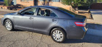2009 Toyota Camry LE FWD parked on the street, showing clean exterior and well-maintained condition.