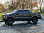 2014 Ford F150 FX4 Supercrew Cab in a parking lot, showcasing its clean design and features.