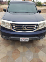 Front view of a 2014 Honda Pilot EX with salvage title, good condition, and 123,000 miles.