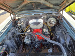 Under the hood of a 1970 Chevrolet Monte Carlo showing a rebuilt engine and components.