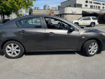 2010 Mazda 3 with 184k miles parked, showcasing its clean exterior and excellent condition.