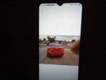 Red 2013 Hyundai Elantra Limited 4-door sedan parked with visible features and sunset background.
