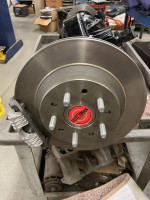 Close-up of a 1934 Pontiac Coupe brake assembly showing detailed components in a workshop setting.