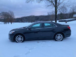 2013 Chevrolet Malibu LT in black parked in snow, low mileage and in excellent condition.