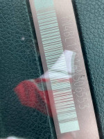 VIN plate of a 2006 Nissan Altima SE with mileage and minor damage details.