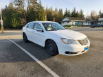 2013 Chrysler 200 in white with 94,850 KM, front view parked in a lot, showing sleek design and alloy wheels