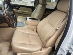 Interior view of a 2007 GMC Yukon Denali with beige leather seats and wooden accents