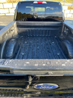 Clean bed of a 2018 Ford F350 XLT FX4 truck with rebuilt status and recent maintenance performed.