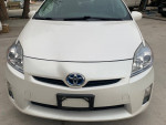 Front view of a 2011 Toyota Prius with clean design, showcasing its hybrid efficiency and modern features.