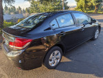 2014 Honda Civic LX in black, showcasing its sleek design and features like backup camera and power options.