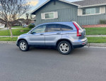 2011 Honda CR-V EX-L SUV parked on street with gray leather seats, fully loaded and in excellent condition.
