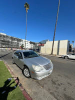 2008 Chrysler Sebring parked on the street, showcasing its silver exterior and surrounding urban environment.