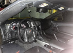 Interior view of a well-maintained 2005 Chevrolet Corvette with a sleek dashboard and black leather seating.