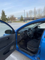 Interior view of a blue 2011 Hyundai Elantra GLS showcasing the front seats and dashboard.
