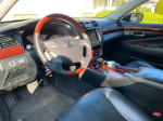 Interior view of a 2007 Lexus LS460 showcasing leather seats, wood accents, and high-tech features.