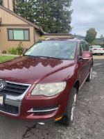 2008 Burgundy Volkswagen Touareg SUV with 100,000 miles, featuring premium sound and four-wheel drive.