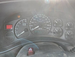 Dashboard of a 2002 Chevrolet Silverado showing mileage at 153586 with service engine light on.