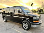 2007 GMC Savana cargo van parked with sunset reflection, perfect for contractors and movers.