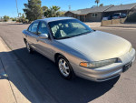 1999 Oldsmobile Intrigue GL in good condition, with 146,000 miles, parked on a residential street.