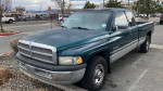 1996 Dodge Ram 2500 Cummins in green, extended cab with long bed and upgraded features parked outdoors.