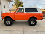 Side view of a 1971 Chevrolet K5 Blazer 4X4 with orange exterior and removable hardtop