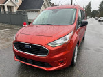 2022 Ford Transit Connect Passenger Wagon in red with premium features and rain on the windshield