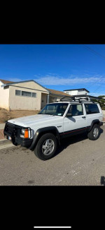 1993 Jeep Cherokee Country RWD parked on the street, showcasing its exterior design.