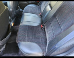 Interior view of the back seat in a 1992 Ford Taurus SHO, featuring cloth upholstery and seat belts.