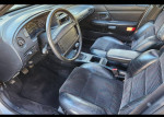 Interior view of a 1992 Ford Taurus SHO with manual transmission, featuring sporty seats and a clean dashboard.