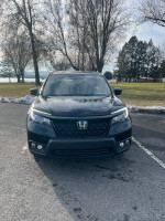 Front view of a 2019 Honda Passport Sport FWD parked outdoors