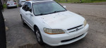 2000 Honda Accord EX FWD with 74,000 miles parked on the street, showing minor wear and tear.