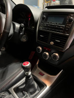 Interior view of 2012 Subaru Impreza WRX STI with leather seats and detailed dashboard.