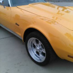 1973 Chevrolet Corvette Stingray in yellow, featuring custom wheels and a sleek body design