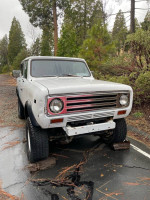 1972 International Scout on display, needing repairs and restoration, parked in a natural setting.
