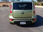 Rear view of a well-maintained 2013 Kia Soul in a parking lot with clean title and low mileage