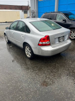 2006 Volvo S40 2.4i in silver, showing rear view with rain-soaked surface, for sale with extensive service history.